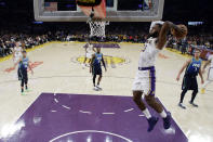 Los Angeles Lakers' LeBron James, right, dunks against the Dallas Mavericks during the second half of an NBA basketball game Sunday, Dec. 1, 2019, in Los Angeles. (AP Photo/Marcio Jose Sanchez)