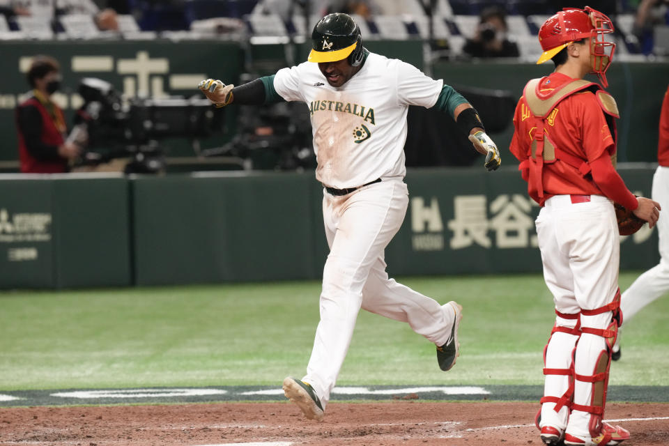 Darryl George of Australia runs across the home plate to complete a run during their Pool B game against China at the World Baseball Classic at the Tokyo Dome, Japan, Saturday, March 11, 2023. (AP Photo/Eugene Hoshiko)