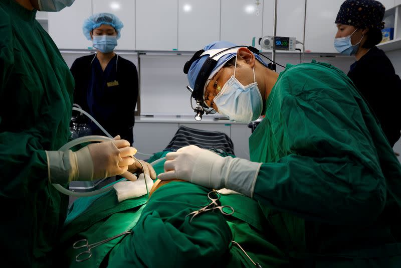 Park Cheol-woo a director of WooAhIn Plastic Surgery Clinic conducts a nose plastic surgery of Ryu Han-na, amid the coronavirus disease (COVID-19) pandemic in Seoul