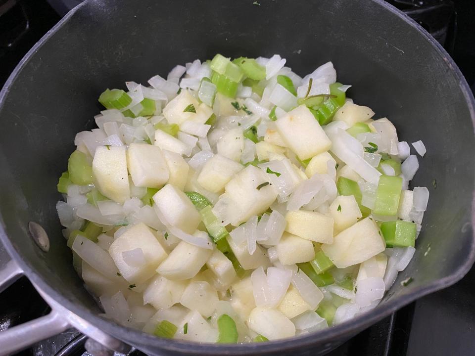 celery and onions cooking in a pan for Ina Garten's stuffing