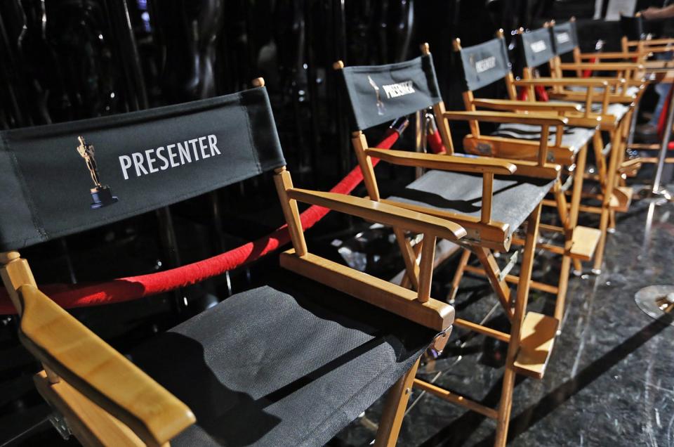 Director's chairs lined up backstage for the presenters at the 2015 Oscars.