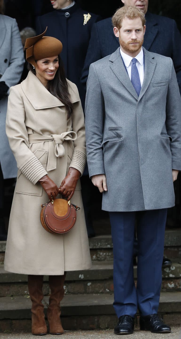 <p>Markle wore a Philip Treacy felt hat, a Sentaler wide-collar camel coat and a burgundy <a class="link " href="https://www.shopbop.com/tay-dress-club-monaco/vp/v=1/1576456913.htm?currencyCode=GBP&extid=SE_froogle_SC_uk&cvosrc=cse.google.CLUBM42971&cvo_campaign=SB_Google_GBP&ef_id=VzsjoQAAAJ0g9mru%3A20180101131438%3As" rel="nofollow noopener" target="_blank" data-ylk="slk:'Tay' velvet dress;elm:context_link;itc:0;sec:content-canvas">'Tay' velvet dress</a> from Canadian clothes brand Club Monaco for Christmas lunch and a church service in Sandringham. </p>