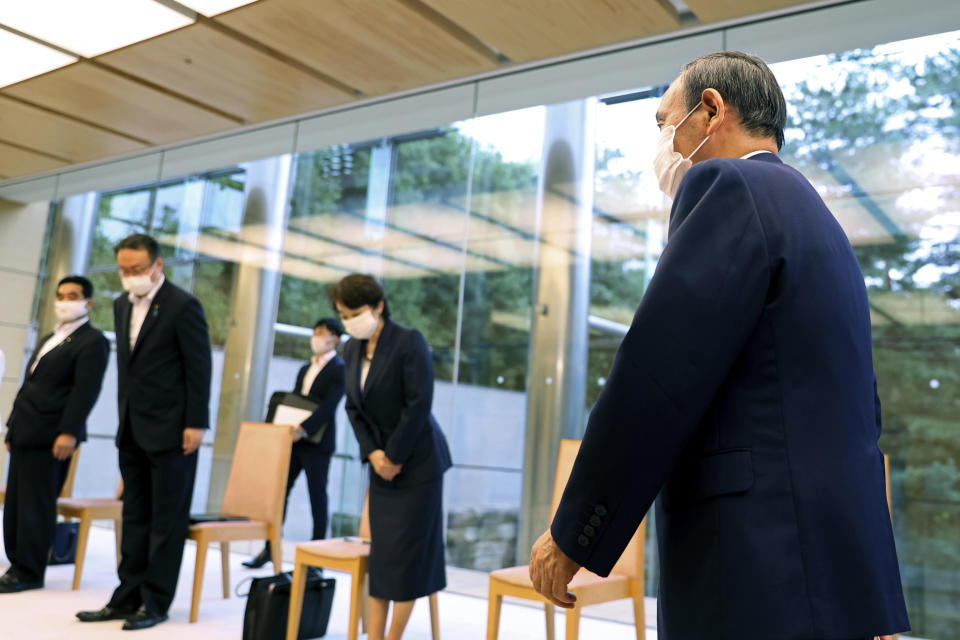 Japanese Primm Minister Yoshihide Suga, right, arrives to meet International Paralympic Committee President Andrew Parsons, in Tokyo Friday, Sept.3, 2021. Suga said Friday he won’t run for leadership of the governing party at the end of this month, paving the way for a new Japanese leader after just a year in office. (Behrouz Mehri/Pool Photo via AP)