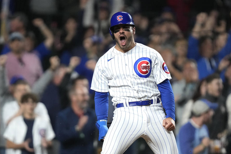 Chicago Cubs' Mike Tauchman reacts after scoring on a two-run single by Ian Happ off Pittsburgh Pirates relief pitcher Yohan Ramirez during the sixth inning of a baseball game Wednesday, June 14, 2023, in Chicago. (AP Photo/Charles Rex Arbogast)