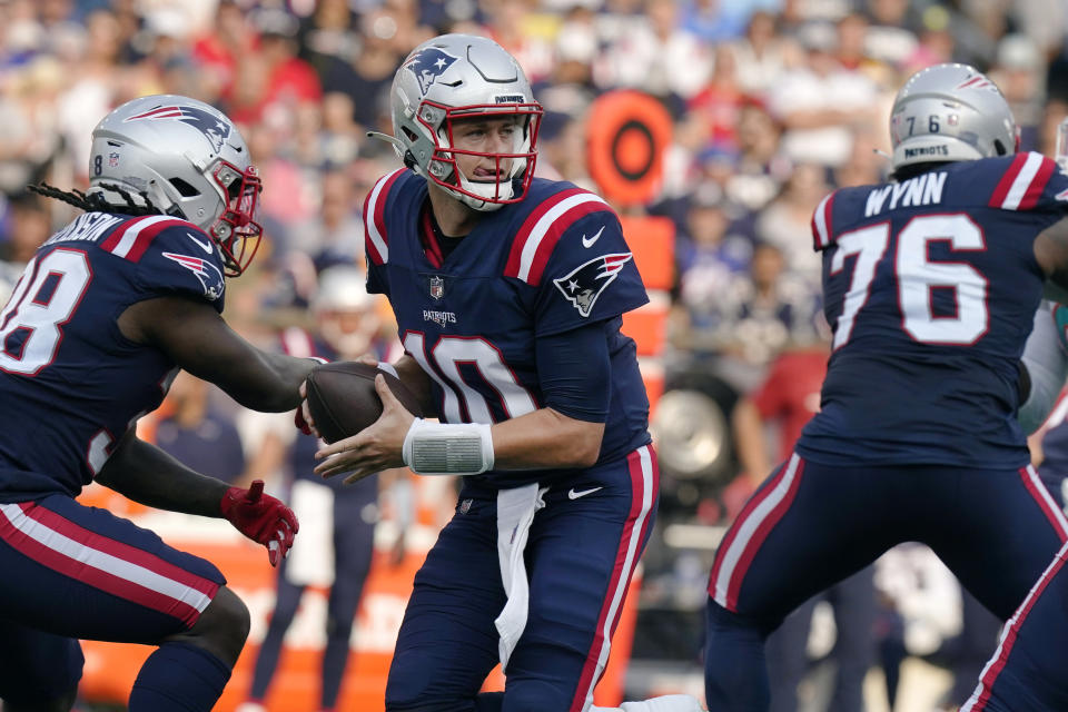 New England Patriots quarterback Mac Jones (10) looks to pass after faking a hand off during the first half of an NFL football game against the Miami Dolphins, Sunday, Sept. 12, 2021, in Foxborough, Mass. (AP Photo/Steven Senne)