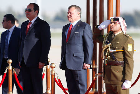 Jordan's King Abdullah II stands next to Egypt's President Abdel Fattah al-Sisi during a reception ceremony at the Queen Alia International Airport in Amman, Jordan March 28, 2017. REUTERS/Muhammad Hamed