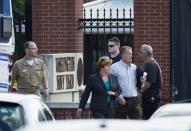 Military and civilian employees leave after a shooting at the Washington Navy Yard in Washington September 16, 2013. (REUTERS/Joshua Roberts)