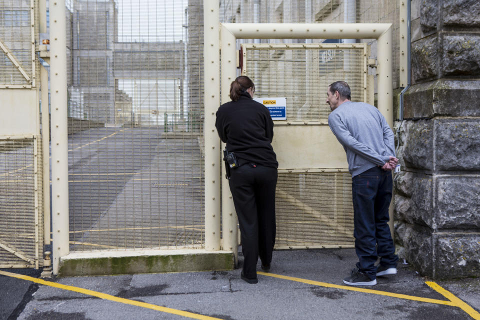 A prisoner accompanied by an officer walking through the prison to visits. HMP/YOI Portland, Dorset. A resettlement prison with a capacity for 530 prisoners. Portland, Dorset, United Kingdom. (Photo by In Pictures Ltd./Corbis via Getty Images)