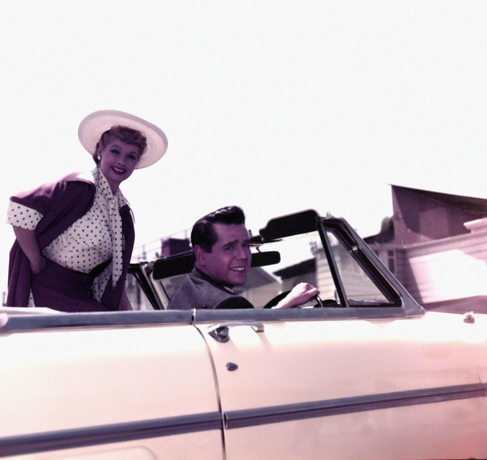 1950: Driving with Desi in a peachy convertible.