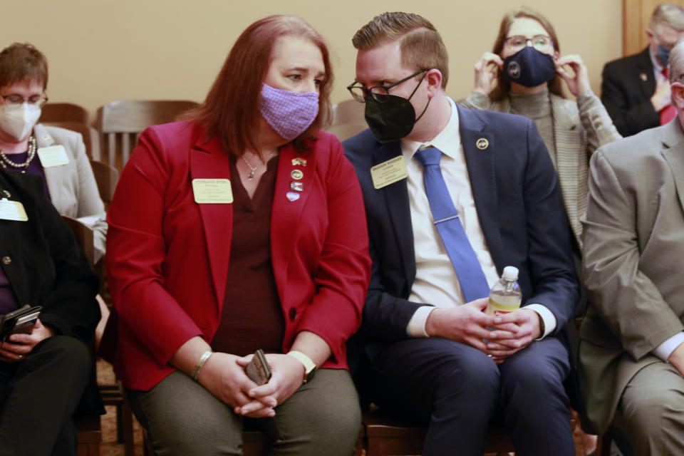 Kansas state Reps. Stephanie Byers, left, D-Wichita, and Brandon Woodard, D-Lenexa, confer during as a Senate committee considers a bill they oppose to ban transgender students from participating in girls' or women's school sports, Tuesday, March 16, 2021, at the Statehouse in Topeka, Kan. Byers is the first elected transgender state lawmaker in Kansas, and Woodard was one of the first two openly gay or lesbian lawmakers. (AP Photo/John Hanna)