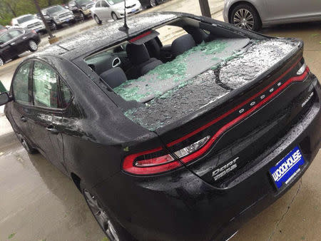 A Dodge Dart car is shown with damage from hail storm in Woodhouse Chrysler Dodge Jeep Ram dealer in Blair, Nebraska on June 3, 2014. REUTERS/Woodhouse Auto Family/Handout