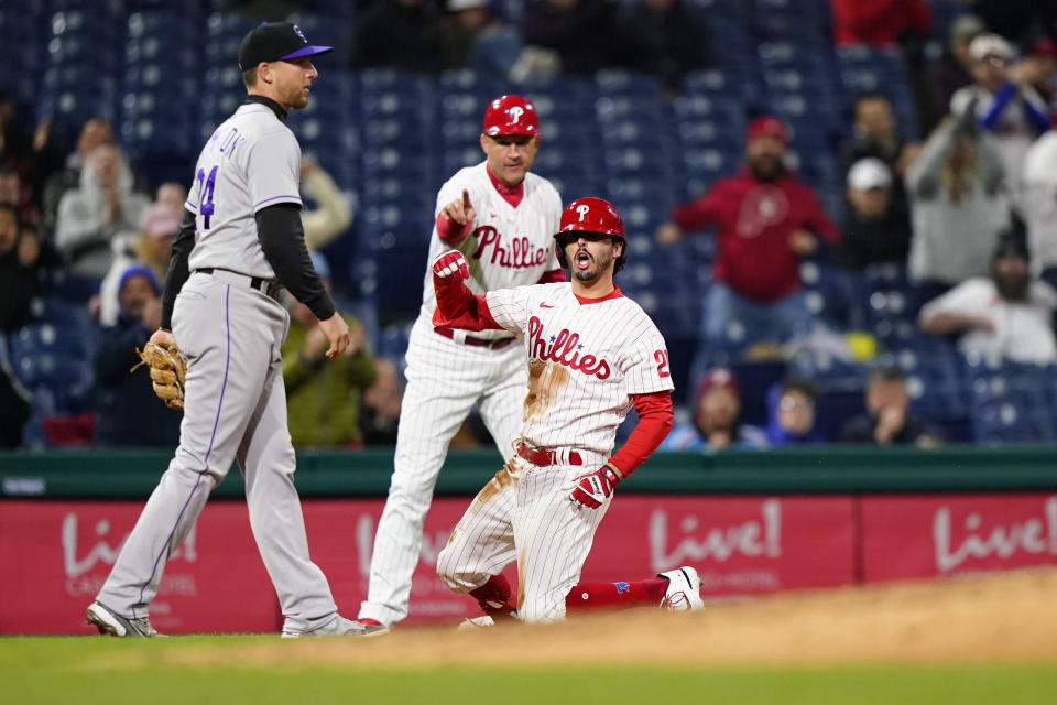 Philadelphia Phillies' Garrett Stubbs, right, reacts after hitting a run-scoring triple during the sixth inning of a baseball game against the Colorado Rockies, Wednesday, April 27, 2022, in Philadelphia. (AP Photo/Matt Slocum)