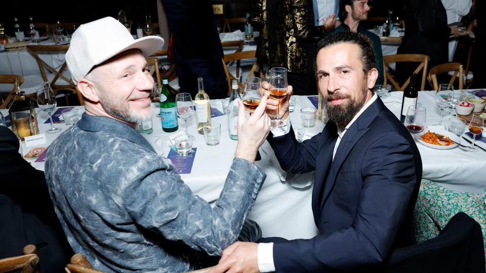 Alberto Candiani and Alessandro Giuggioli sit together at a dinner table