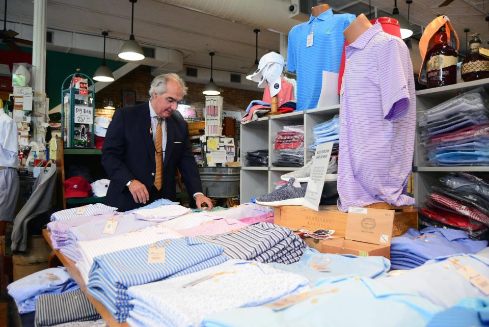 Charles Spurlin, owner of The Shirt Shop, sorts through shirts on Friday, April 23, 2021, for a photo.