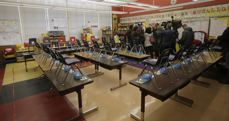 John Sasaki, communications director with Oakland Unified School District, speaks to reporters in an empty classroom at Manzanita Community School in Oakland, Calif., Thursday, Feb. 21, 2019. Teachers in Oakland, California, went on strike Thursday in the country's latest walkout by educators over classroom conditions and pay. (AP Photo/Jeff Chiu)