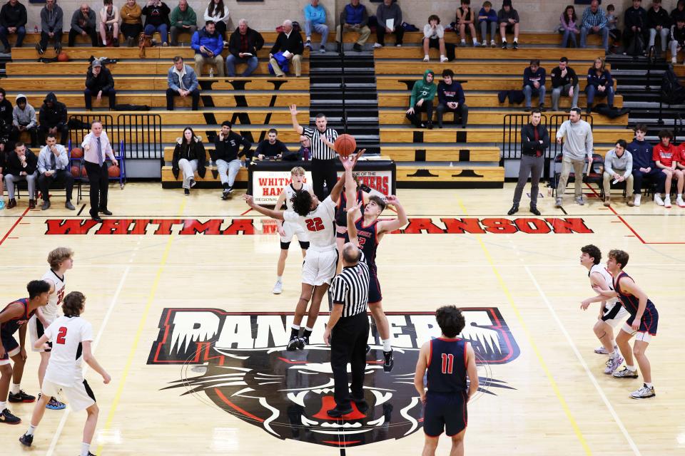 From left, Whitman-Hanson's Isaiah Bean-Brittian and Pembroke's Brady Spencer tip-off the basketball to start the regular season on Tuesday, Dec. 13, 2022.