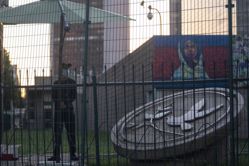 A security guard stands guard behind fences around the U.S. embassy in Beijing on Sept. 6, 2021. The Chinese government says at least 500 Chinese students have been rejected under a policy issued last year by then U.S. President Donald Trump that is aimed at blocking Beijing from obtaining U.S. technology with possible military uses. (AP Photo/Ng Han Guan)