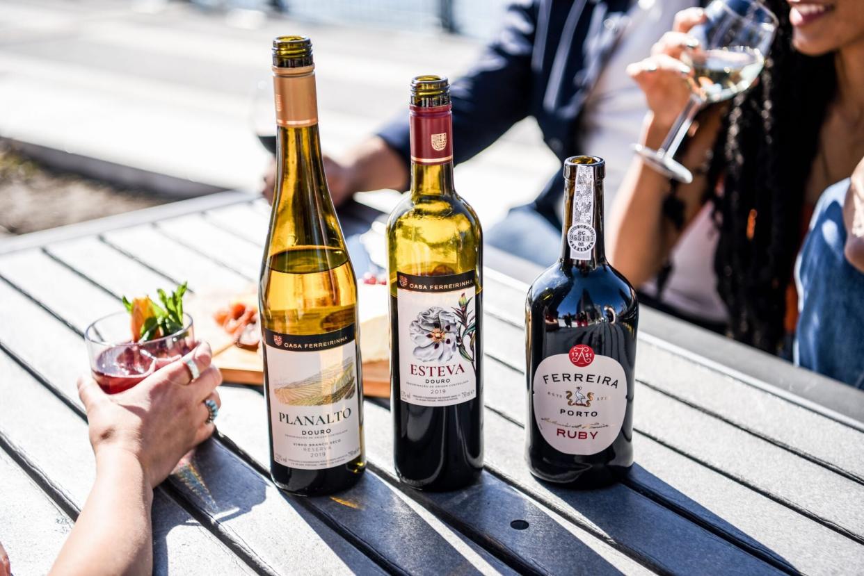 group of friends drinking casa ferreirinha wines outdoors