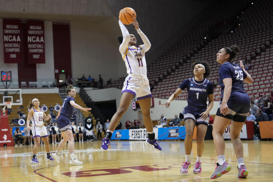 Tennessee Tech guard Maaliya Owens (11) shoots in front of Monmouth guard Ariana Vanderhoop (1) during the second half of a First Four college basketball game in the NCAA women's basketball tournament in Bloomington, Ind., Thursday, March 16, 2023. Tennessee Tech won 79-69. (AP Photo/AJ Mast)