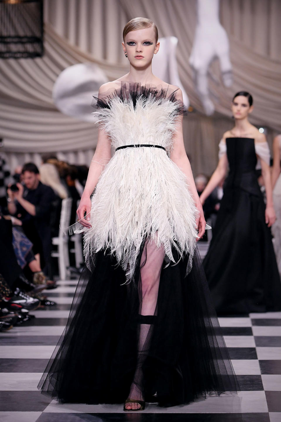 <p>Model wears a white and black feathered bodice gown featuring black tulle, from the Dior SS18 Haute Couture show. (Photo: Getty Images) </p>