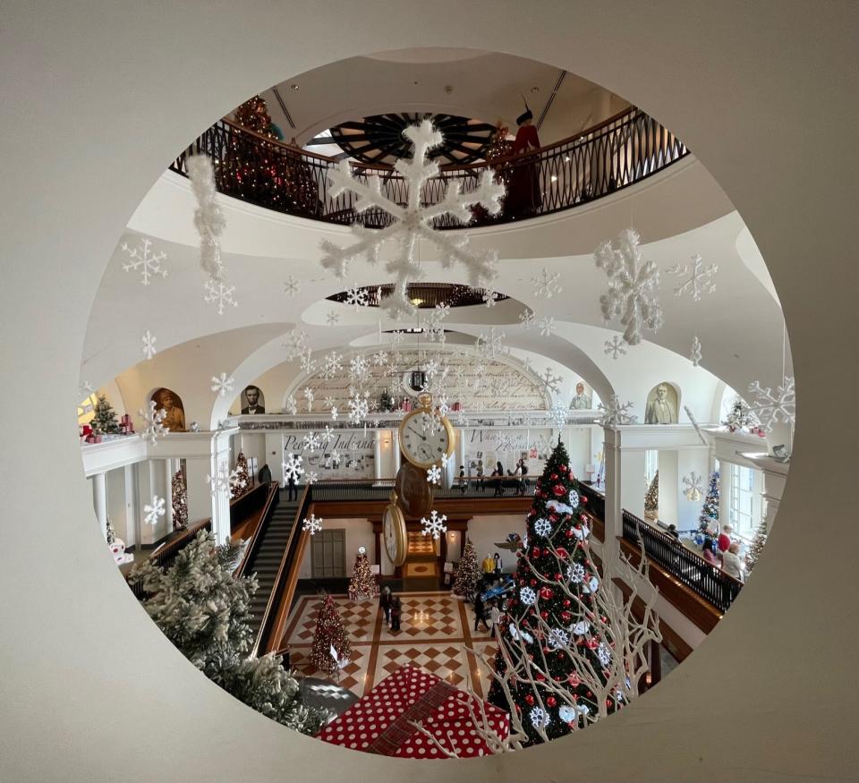 A second-story window frames a holiday view of Eli Lilly Hall during the Festival of Trees.