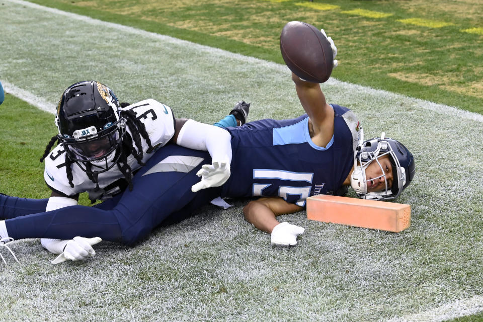 Tennessee Titans wide receiver Nick Westbrook-Ikhine (15) celebrates after scoring past Jacksonville Jaguars cornerback Tre Herndon (37) during the second half of an NFL football game Sunday, Dec. 11, 2022, in Nashville, Tenn. (AP Photo/Mark Zaleski)