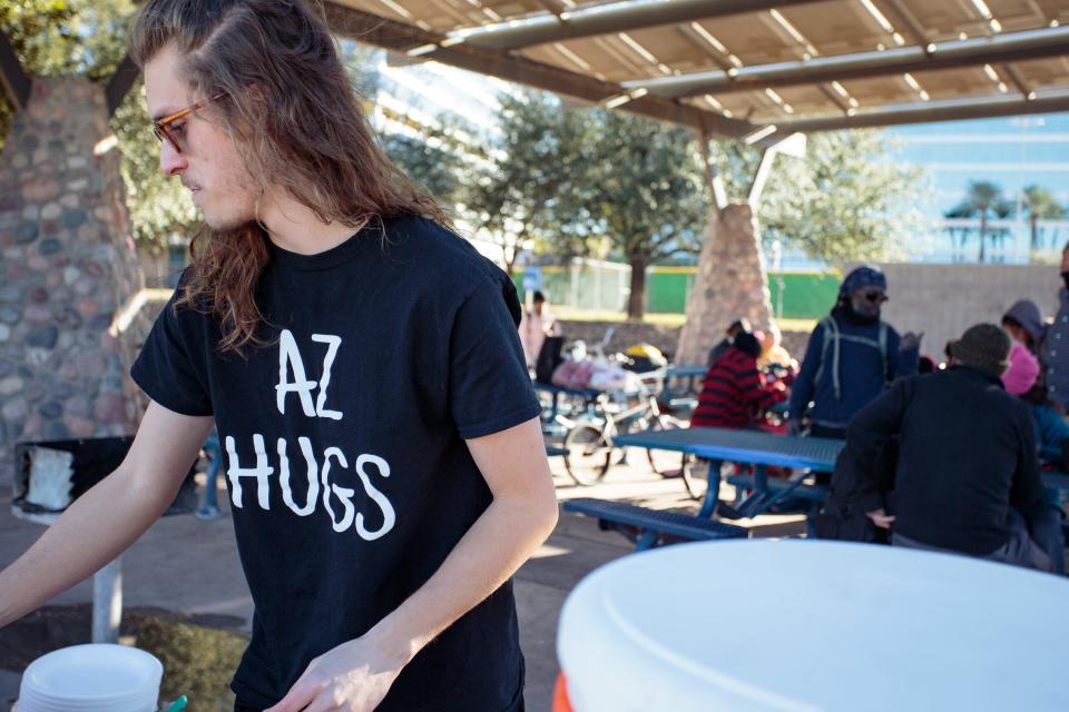 Community outreach organizer Austin Davis wears an "AZ Hugs" shirt at a weekly AZ Hugs for the Houseless event at Tempe Beach Park on Jan. 2, 2022.