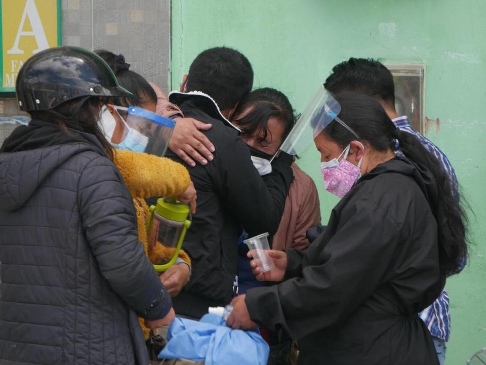 Relatives of a COVID-19 patient in critical condition console one another outside a hospital in Cajamara, Peru, on May 8, 2021.