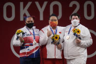 Gold medalist Li Wenwen of China, center, poses with silver medalist Emily Jade Campbell of Britain, left, and bronze medalist Sarah Elizabeth Robles of the United States, in the medals ceremony for the women's +87kg weightlifting at the 2020 Summer Olympics, Monday, Aug. 2, 2021, in Tokyo, Japan. (AP Photo/Luca Bruno)