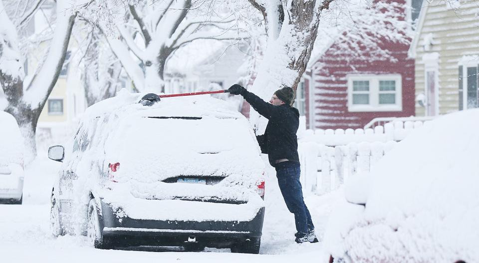 John Cplley removes snow from his car after receiving almost 9 inches of snow in a winter storm at Harding Avenue on Tuesday, Jan. 9, 2024, in Ames, Iowa.