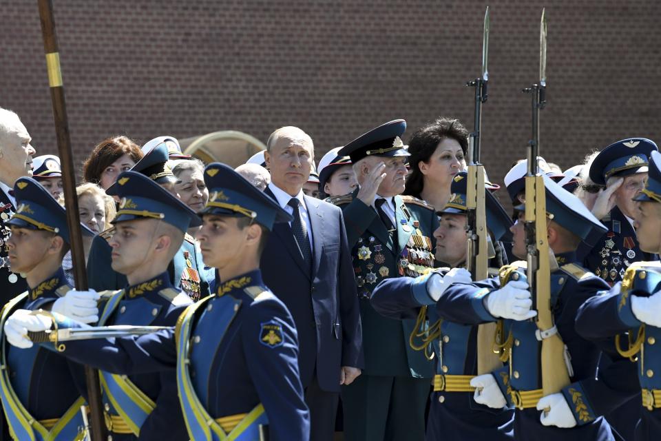 Russian President Vladimir Putin, center, takes part in a wreath laying ceremony at the Tomb of Unknown Soldier in Moscow, Russia, Monday, June 22, 2020, marking the 79th anniversary of the Nazi invasion of the Soviet Union. (Alexei Nikolsky, Sputnik, Kremlin Pool Photo via AP)