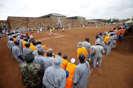 Kenyan prisoners watch a mock World Cup soccer match between Russia and Saudi Arabia, as part of a month-long soccer tournament involving eight prison teams at the Kamiti Maximum Prison, Kenya's largest prison facility, near Nairobi, Kenya, June 14, 2018. REUTERS/Baz Ratner