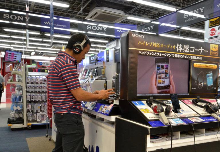 A customer checks out products of Japanese electronics giant Sony, at a shop in Tokyo, on September 18, 2014