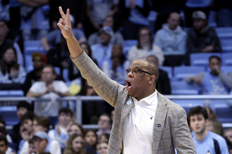 North Carolina coach Hubert Davis signals to the team during the second half of the team's NCAA college basketball game against Louisville, Wednesday, Jan. 17, 2024, in Chapel Hill, N.C. (AP Photo/Chris Seward)