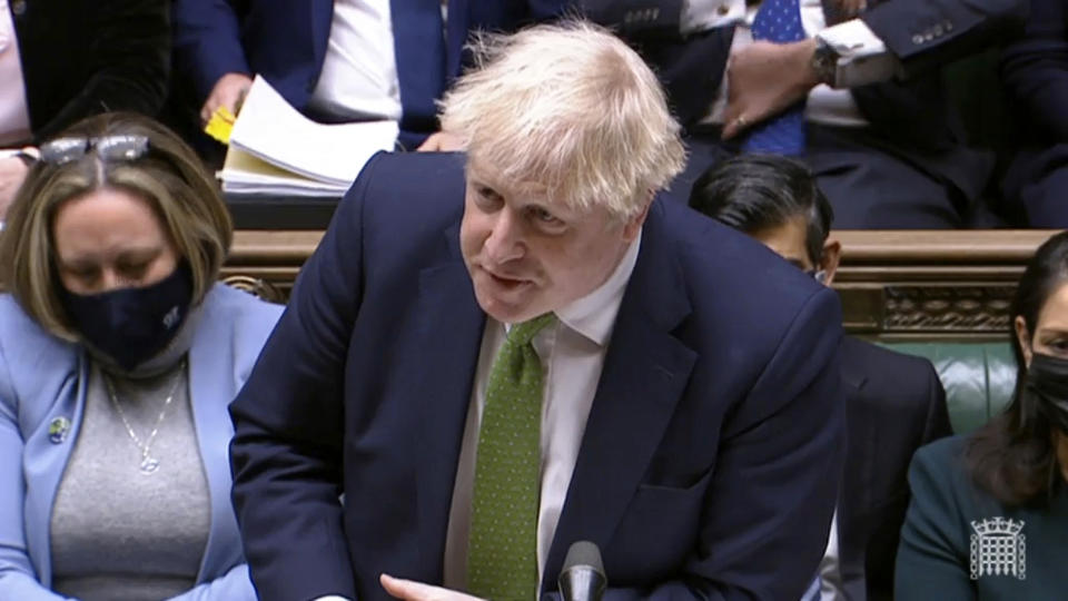 In this screen shot taken from video, Britain's Prime Minister Boris Johnson speaks during Prime Minister's Questions in the House of Commons, London, Wednesday, Jan. 19, 2022. Johnson faced a grilling from opponents in Parliament as well as a threat from his own party's lawmakers over a string of lockdown-flouting government parties. Conservative legislators are judging whether to trigger a no-confidence vote in Johnson over the “partygate” scandal. Johnson and loyal ministers are trying to bring rebels back into line before they submit letters to a party committee calling for the vote. (House of Commons/PA via AP)