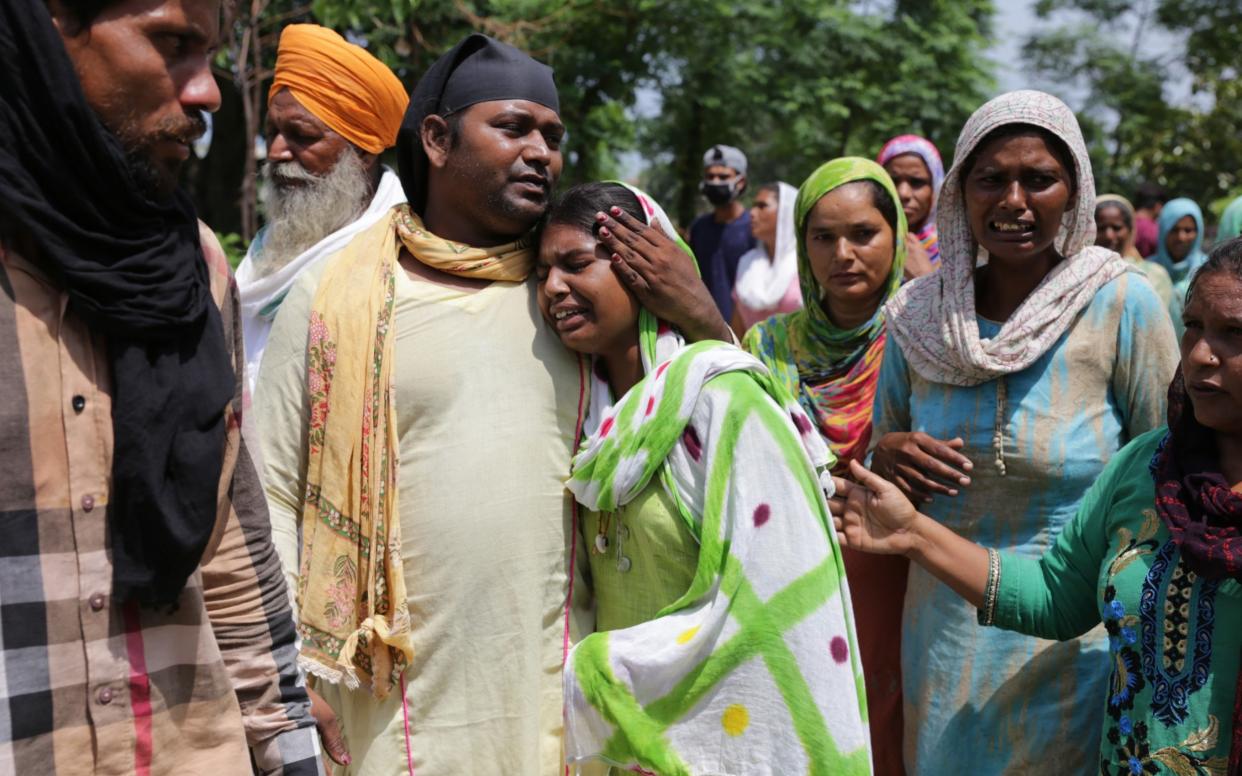 Relatives at the funeral of Karpal Singh, who died after allegedly consuming the alcohol in Punjab - EPA