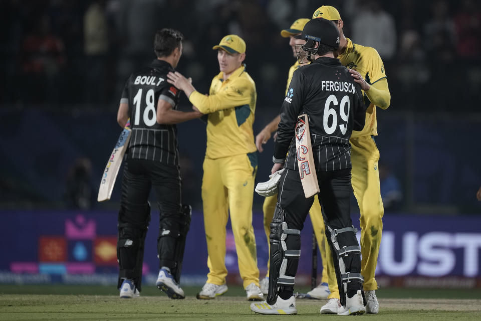 New Zealand's Lockie Ferguson, left, and Trent Boult shake hands with Australian players after they lost the ICC Men's Cricket World Cup match against Australia in Dharamshala, India,Saturday, Oct. 28, 2023. (AP Photo/Ashwini Bhatia)