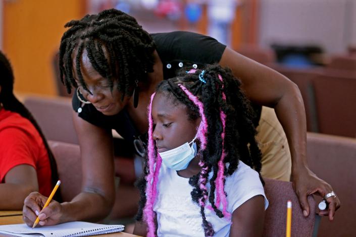 Teacher Patricia Bent goes over fractions with Janyla Jackson, 11, in the GreenTree Summer Enrichment program in Milwaukee.
