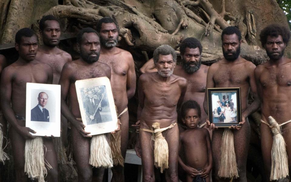 Tribesmen holding portraits of Britain's Prince Philip in the town of Yaohnanen - Dan McGarry/AFP