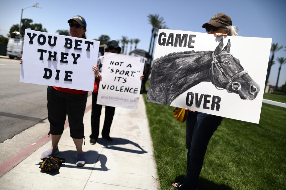 Animal rights activists protest horse racing deaths outside Santa Anita Park in Arcadia back in June. More than 30 horses have died after suffering injuries at the race track since December. (Photo: Mario Tama via Getty Images)