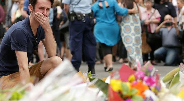 A man cries as he pays his respect at Martin Place in Sydney, just metres from the scene of a tragic hostage situation in Lindt Chocolate Cafe. Photo: Mark Metcalfe/Getty Images