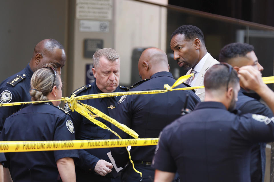 Atlanta Mayor Andre Dickens, second from right, and Atlanta Police Chief Darin Schierbaum work at the scene where multiple people were injured during a shooting at Peachtree Center in downtown Atlanta. (Miguel Martinez/Atlanta Journal-Constitution via AP)