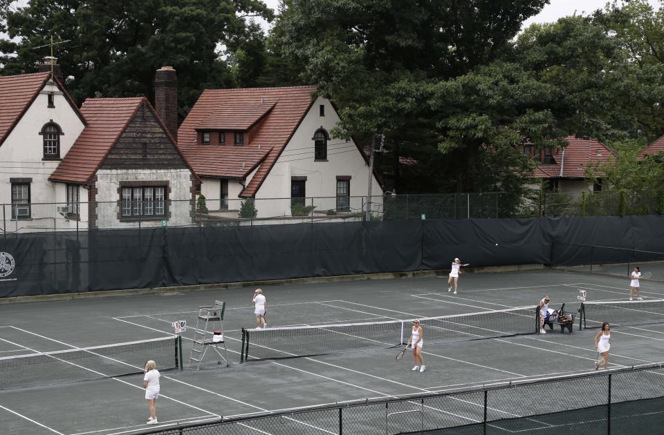 In this Tuesday, July 2, 2013 photo, women play tennis at the West Side Tennis Club in the Queens section of New York. The Beatles. The Rolling Stones. Frank Sinatra. Jimi Hendrix. Bob Dylan. They’ve all held court at the more than century-old West Side Tennis Club in Queens’ Forest Hills neighborhood - for six decades the site of the U.S. Open Tennis Championships. Plans are now in the works for the grassy lawn to come alive again with the sound of music, starting with a concert featuring the British band Mumford & Sons, to be followed by a lineup of world-class musicians. (AP Photo/Seth Wenig)