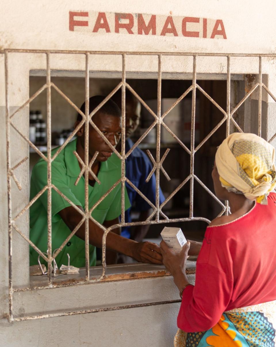 A woman collects medicines from a rural clinic in Mozambique, after Project Last Mile helped the Ministry of Health advance a strategic plan for pharmaceutical logistics (Drew Slattery)