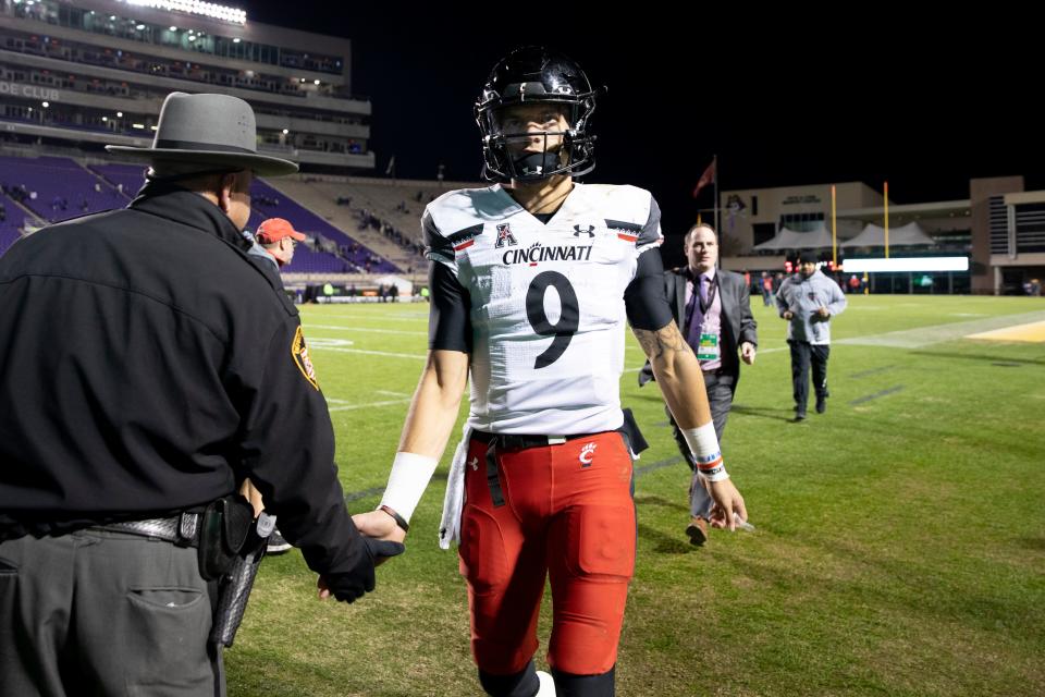 Cincinnati Bearcats quarterback Desmond Ridder (9) high fives a Hamilton County Deputy after the NCAA football game at Dowdy-Ficklen Stadium in Greenville, NC, on Friday, Nov. 26, 2021. Cincinnati Bearcats defeated East Carolina Pirates 35-13. 