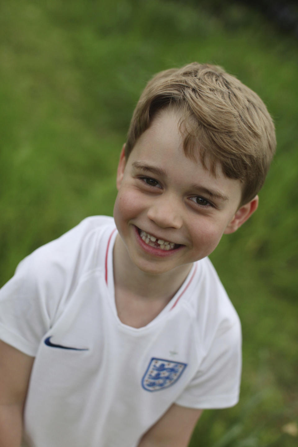 In this undated photo released by the Duke and Duchess of Cambridge on Sunday, July 21, 2019, Britain's Prince George poses for a photo taken by his mother, Kate, the Duchess of Cambridge, in the garden of their home at Kensington Palace, London. Prince George will celebrate his sixth birthday on Monday, July 22. (The Duchess of Cambridge via AP)