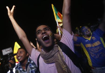 Sri Lanka's cricket fans cheer, after watching Sri Lanka win the ICC Twenty20 World Cup cricket title by beating India, in Colombo April 6, 2014. REUTERS/Dinuka Liyanawatte