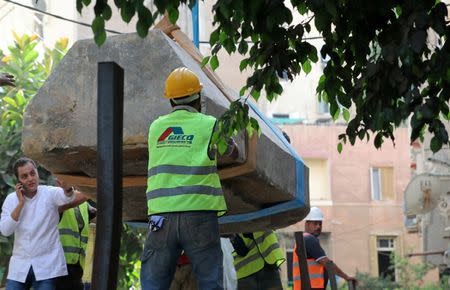 Coffin is moved over by a truck after archaeologists unearthed a sarcophagus containing three mummies in Alexandria, Egypt July 19, 2018. REUTERS/Mohamed Abd El Ghany