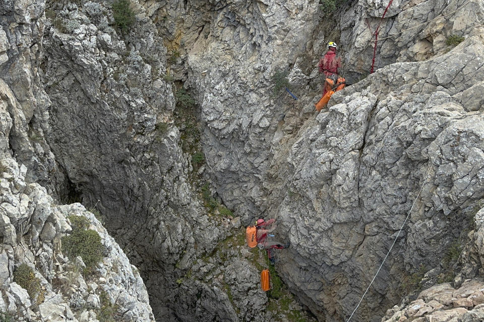 European Cave Rescue Association (ECRA) members work next to the entrance of Morca cave near Anamur, southern Turkey, Thursday, Sept. 7, 2023. Turkish and international cave rescue experts are working to save an American speleologist trapped at a depth of more than 1,000 meters (3,280 feet) in a cave in southern Turkey after he became ill. (Huseyin Yildiz/IHA via AP)