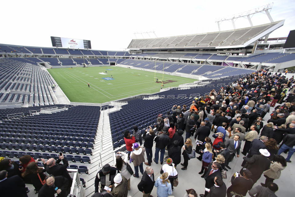 FILE - In this Nov. 19, 2014, file photo, city officials and guests get a preview of the new Citrus Bowl stadium, also known as Camping World Stadium, in Orlando, Fla. There are 23 venues bidding to host soccer matches at the 2026 World Cup in the United States, Mexico and Canada. (AP Photo/John Raoux, File)